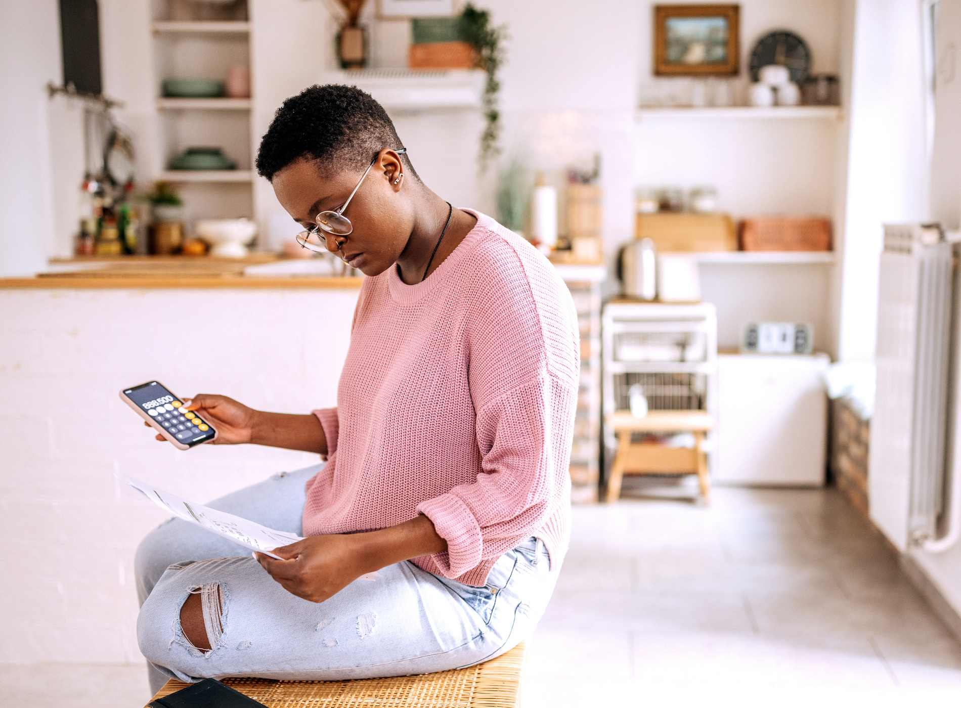 Young beautiful woman going over finances at home