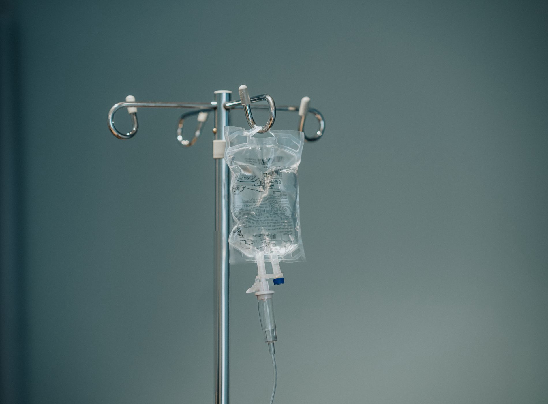 Close up of Intravenous drip bag with chemotherapy drug hanging in hospital treatment room.