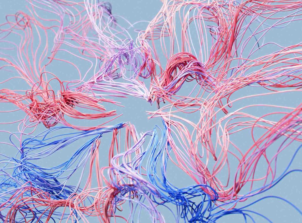 Digitally generated image of red and blue wires intertwined in the air. The wires form intricate patterns against the light blue background, creating a visually captivating scene that evokes creativity and innovation.