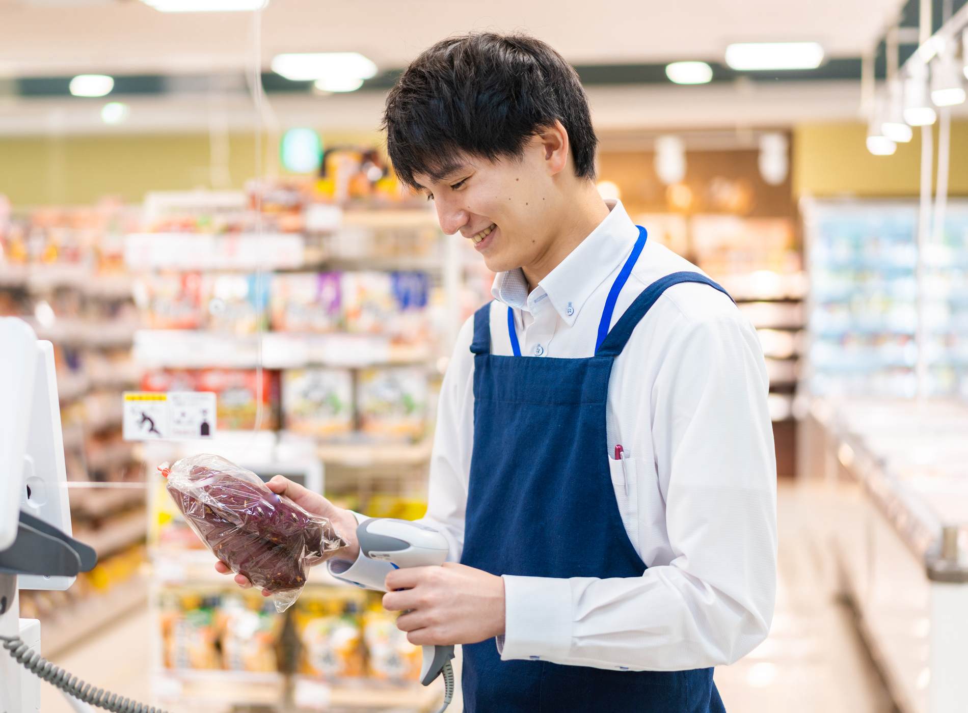 Staff working at the cash register in a supermarket