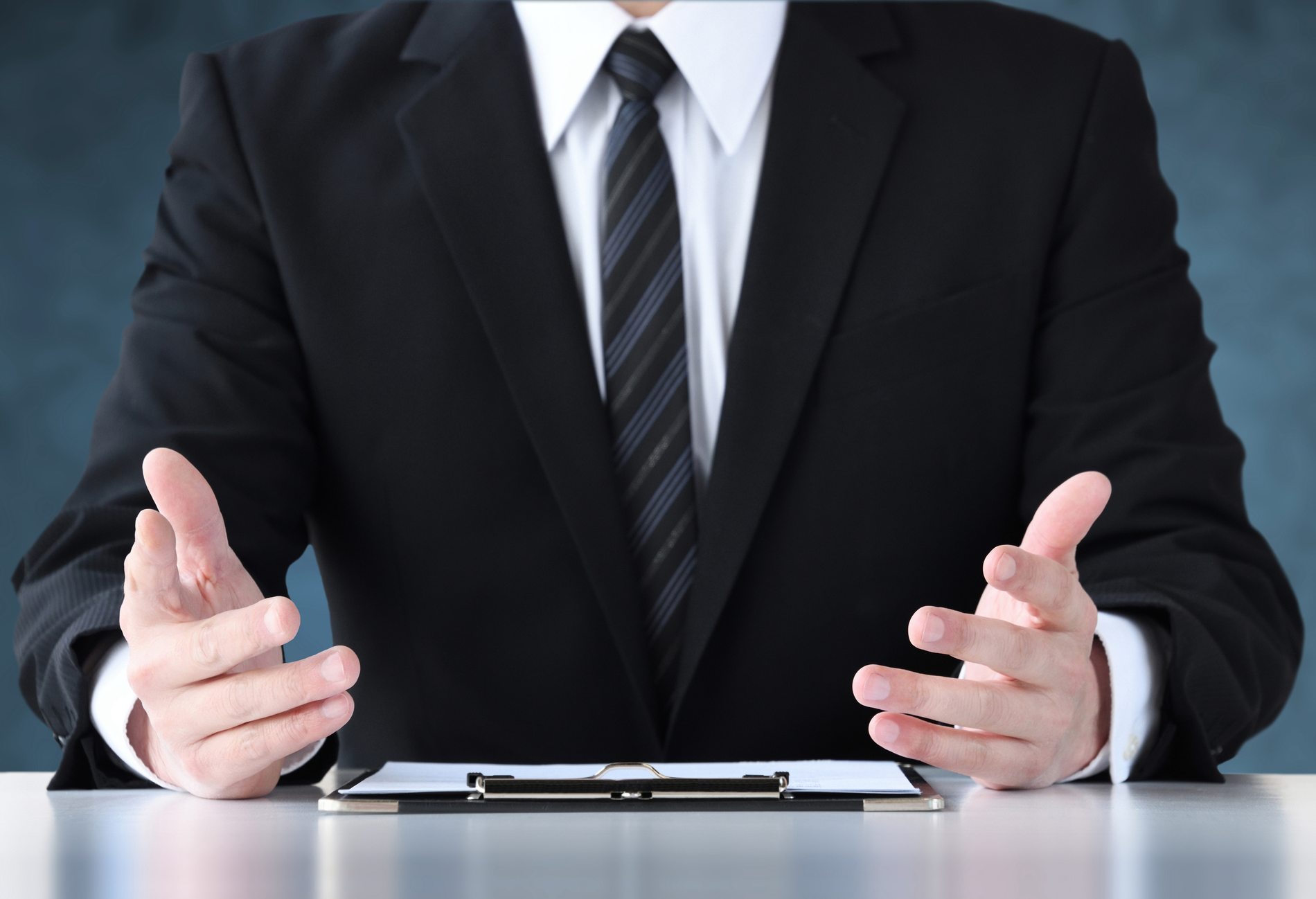 Talking businessman on dark blue background