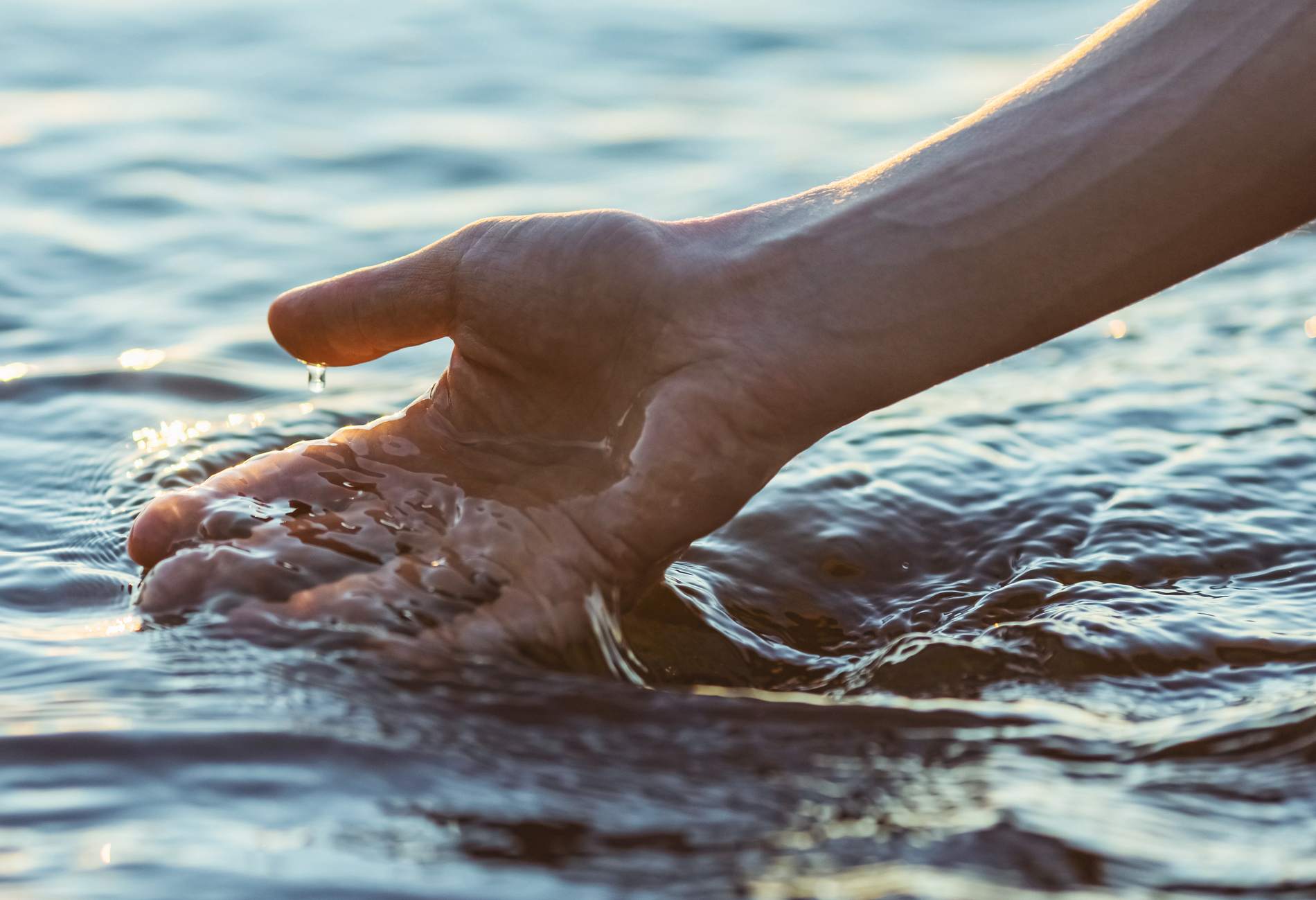 Hand touching water.