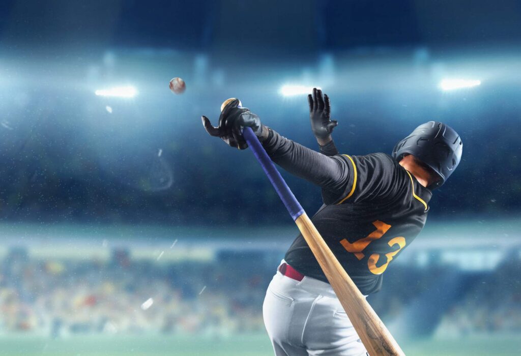 Powerful shot, serve. Professional baseball player in motion, action during match at stadium over blue evening sky with spotlights. Concept of movement and action, sport lifestyle, competition