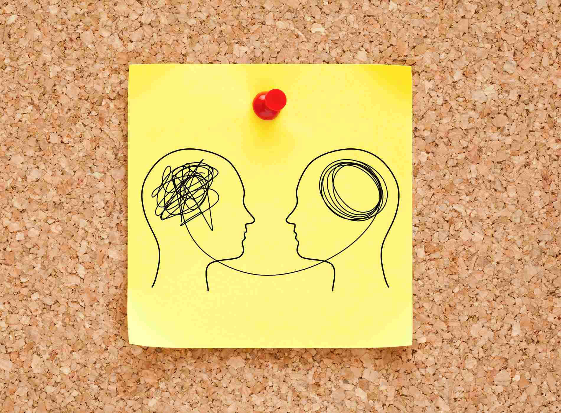 Brain Fog Brain Rot Mental Health concept drawn on yellow sticky note pinned on cork bulletin board.