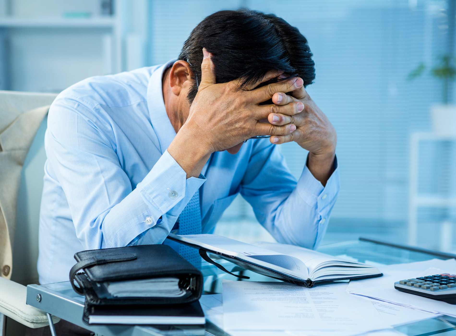 Worried businessman working at his desk in office