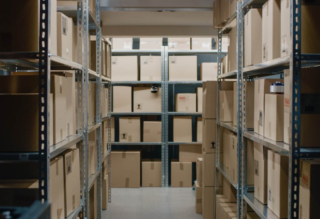 Shot Inside Warehouse Storeroom with Rows of Shelves Full Cardboard Boxes, Parcels, Packages Ready For Shipment.