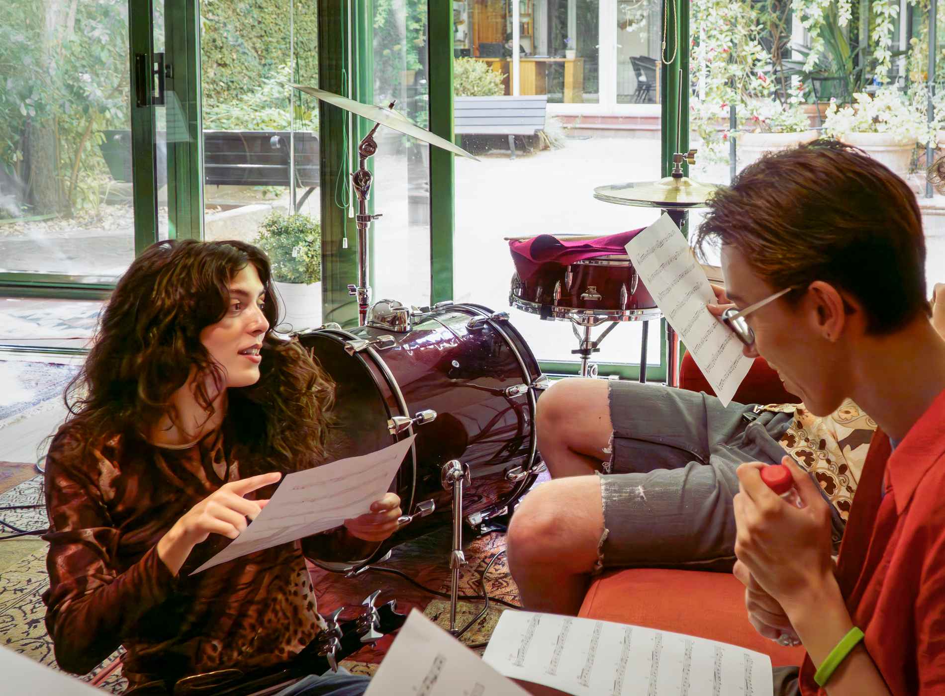 Young musicians reading sheet music during a break in rehearsal